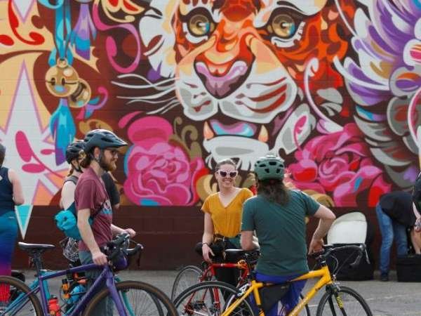 Bicyclists in front of Mural in South Salt Lake