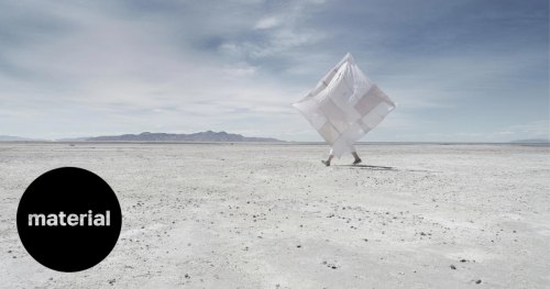 Woman flying a quilt over the salt flats